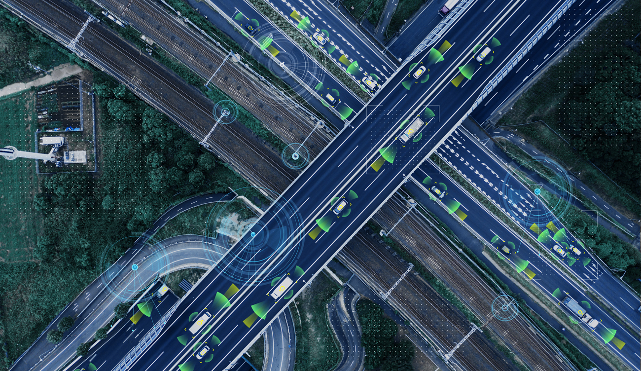 A birds-eye view of a crossing over a motorway with autonomous cars driving along it